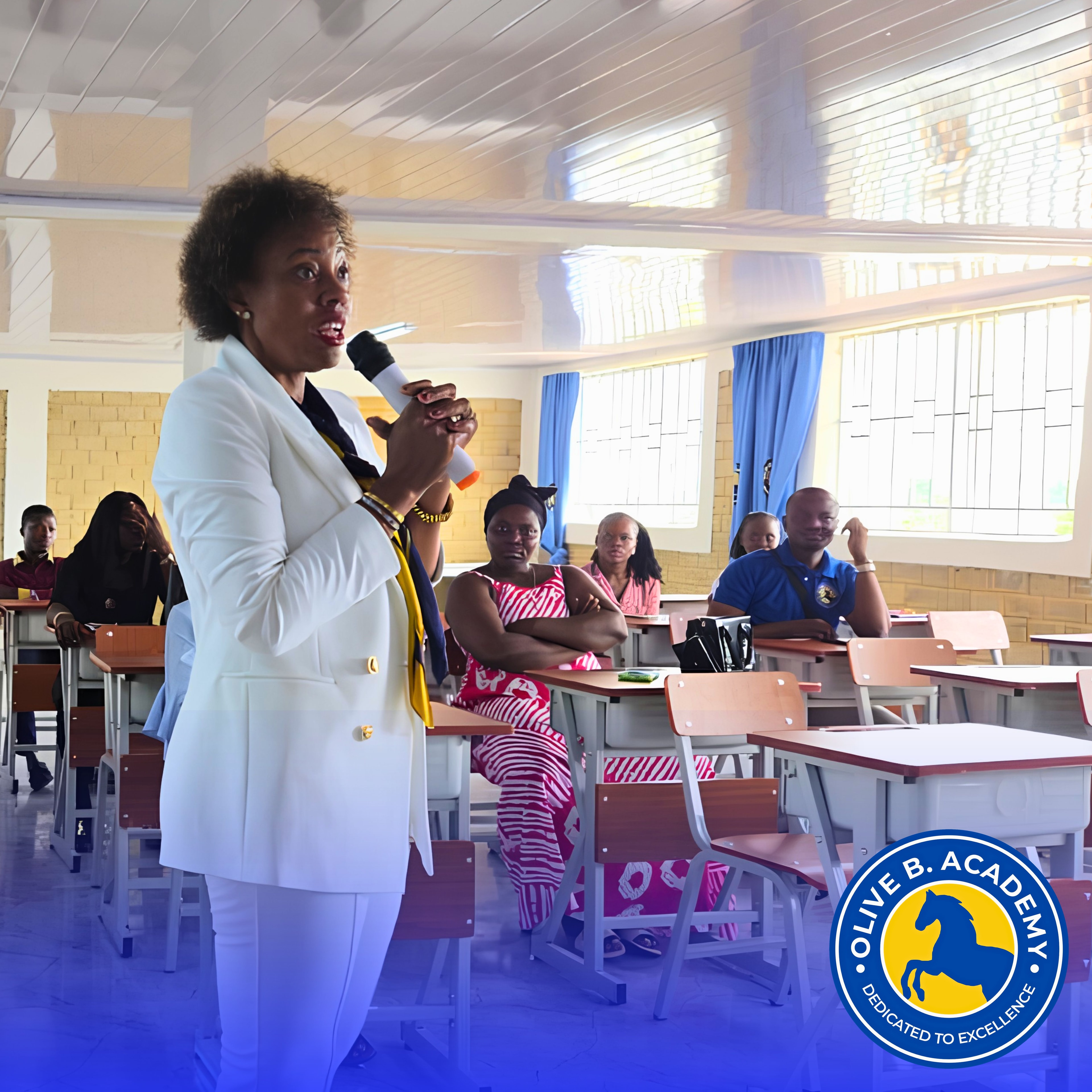 Olive Baimba speaking to students and parents inside an Olive B. Academy classroom